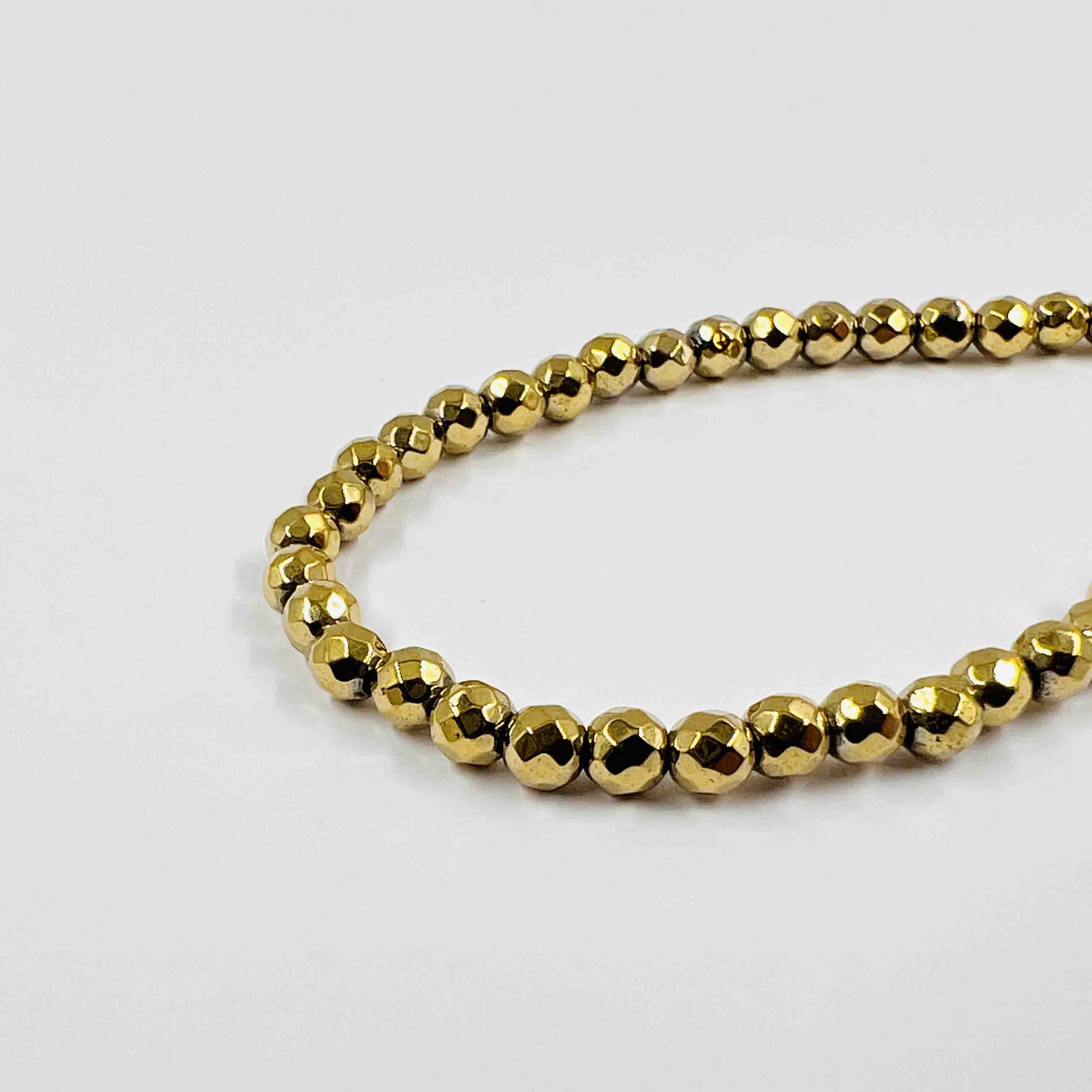 Boule hématite facettée dorée